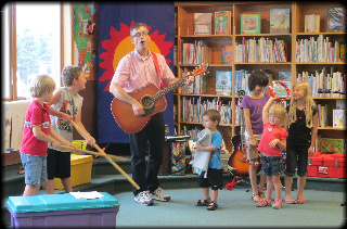 Children singing with Kevin Devine